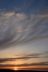Fototapeta na wymiar Evening sunset and sun with clouds and horizon