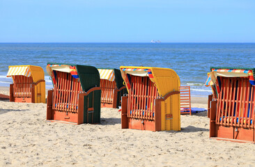 Roofed wicker beach chairs. Egmond aan Zee, North Sea, the Netherlands.