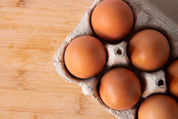 Fresh farm eggs in the cardboard boxes for storing eggs. Packaging for chicken made of recycled waste paper and paper