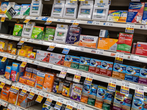 Kirkland, WA USA - circa September 2021: Angled view of cold, flu, and sinus medications for sale inside a QFC grocery store.
