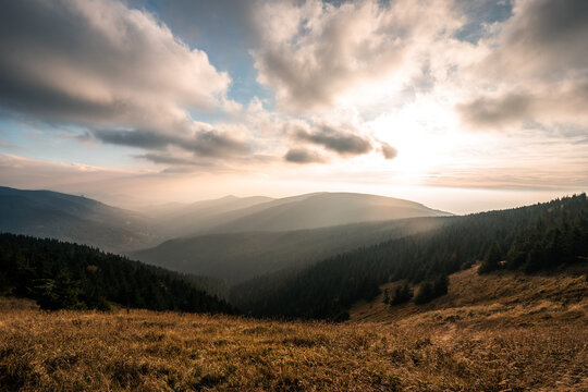 Landscape of warm light sun rays on sky through the clouds over the mountains in Czech republic, Jeseniky