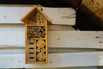 a wooden house,hotel hung on the woodshed, a shelter for wild insects, worker bees