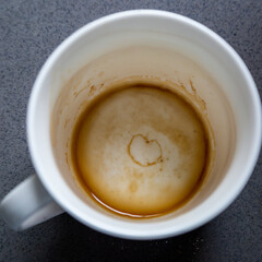 Looking down at the heart shape outline at the bottom of a coffee cup