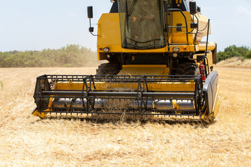 Fototapeta na wymiar Combine harvester harvesting barley fields