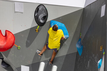 Climbing. Sport. Young person climbing in Block Climbing. Olympic exercise. Olympic Sport....