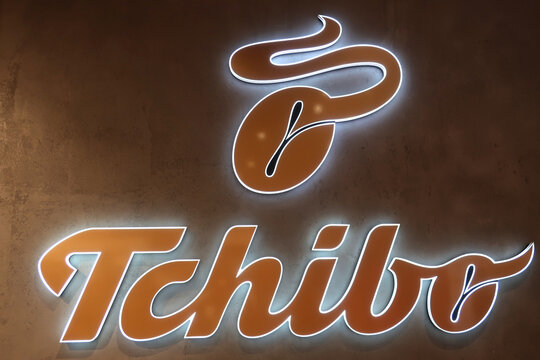 Tchibo signage, logo, emblem on the wall of a German chain of coffee retailers. WARSAW, POLAND - MARCH 29, 2022