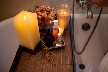 Slim white woman with long hair in the bath room with window. White towel on the body. Morning time.