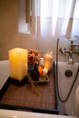 Slim white woman with long hair in the bath room with window. White towel on the body. Morning time.