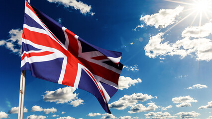 Obraz premium UK, United Kingdom, Union Jack flag waving in sky