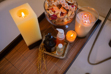 In the bath room with cosmetics and candle. Spa care body. Morning time and shower.