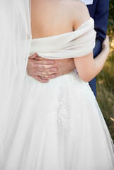 Happy wedding couple hugging on ceremony outdoors, copy space. Close up of young bride and groom