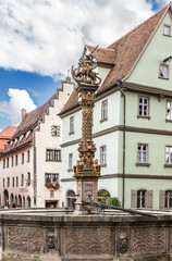 Fototapeta na wymiar Rothenburg ob der Tauber, Germany. Medieval fountain Georgsbrunnen on the Market Square