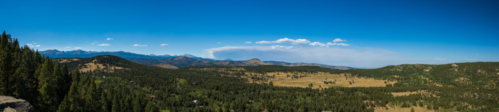 panorama of the mountains with distant smoke cloud