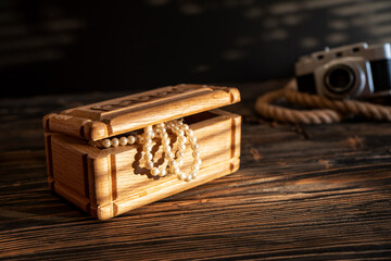 Treasure chest on aged wooden background. An old carved chest on rough wooden background.
Abstract...
