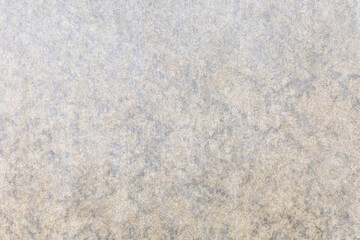 Gray abstract background in the form of a concrete fence with a rough surface