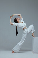 Beautiful young modern dancer or fitness dancer on a white isolated background