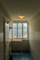 photograph of a hallway with an entrance to a bathroom and a window with alpine scenery in hallstatt austria