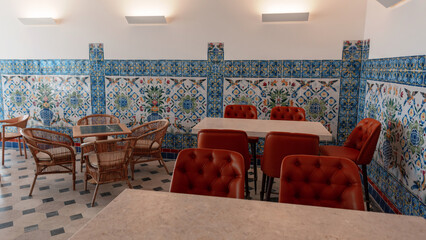 An antique Portuguese cafe in Lisbon by the pier with art azulejo tiles and patterns with chairs and tables