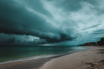 Tropical storm with dark clouds and Caribbean white sand beach before the rain in Playa del Carmen 