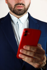 Handsome boy in a nice blue suit, highlighting his left hand to celebrate left-handers day.