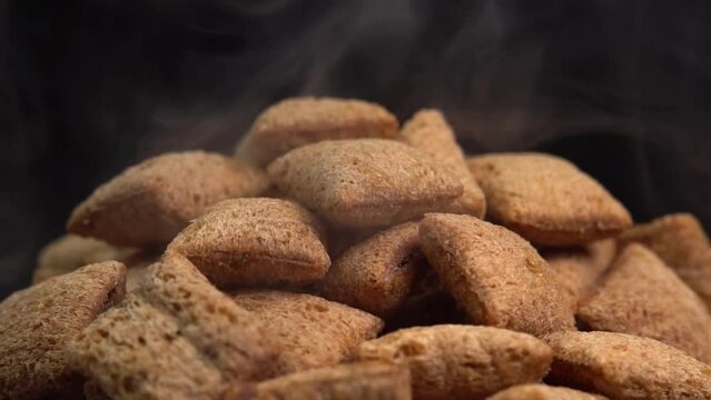 Hot crispy chocolate pads with smoke rotate on a black
