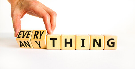 Anything or everything symbol. Businessman turns cubes and changes the concept word Anything to Everything. Beautiful white background. Business motivational anything everything concept. Copy space.