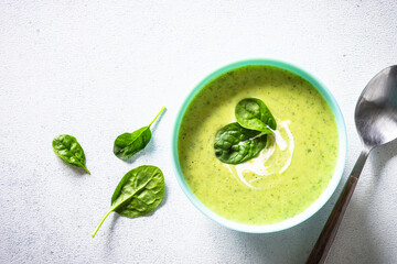 Green soup. Spinach cream soup at white background. Healthy vegan dish. Top view with copy space.