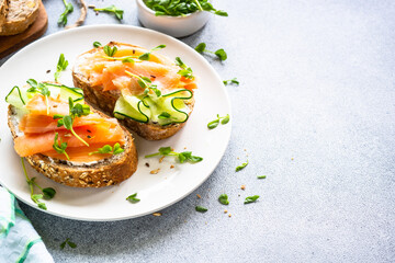 Open sandwich with cream cheese, salmon and cucumber. Healthy breakfast or snack. Top view with copy space.