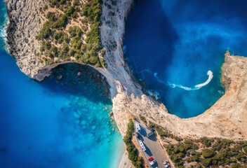 Aerial view of blue sea, mountains, white sandy beach at sunset in summer. Porto Katsiki, Lefkada island, Greece. Beautiful landscape with sea coast, lagoon, rocks, azure water, green forest. Top view - obrazy, fototapety, plakaty