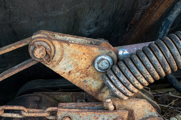 Rusty old spring. Part of agricultural machinery. Steampunk style. High quality photo