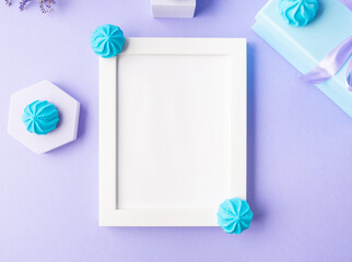 White empty frame on purple background with blue sweet decor