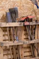 Spades and hoes, garden tools stored in a wooden shed