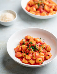 Gnocchi with tomato sauce and parmigiano on a plate