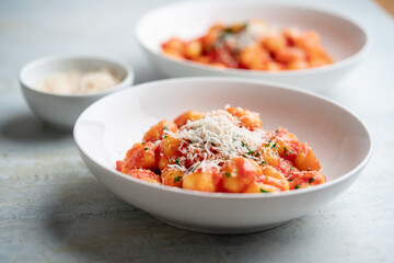 Gnocchi with tomato sauce and parmigiano on a plate