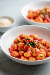 Gnocchi with tomato sauce and parmigiano on a plate