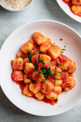 Gnocchi with tomato sauce and parmigiano on a plate