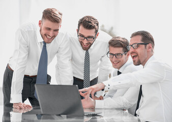 smiling business team looking at the laptop screen