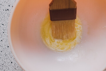 paintbrush in liquid butter