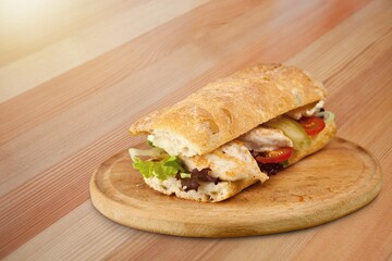 DÃ¶ner Kebab Doner Kebap fast food snack in flatbread on a wooden board desk
