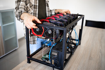 Unrecognizable person or an expert building new mining rig for bitcoin cryptocurrency. Blockchain...