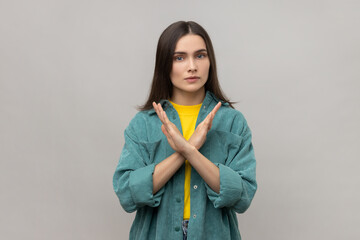 Never, no compromise. Dissatisfied woman crossing hands, showing x sign, ban or prohibition...