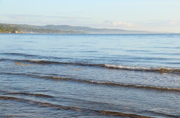 Layer of gentle waves of the ocean in the morning sun, Sogod, Cebu, Philippines
