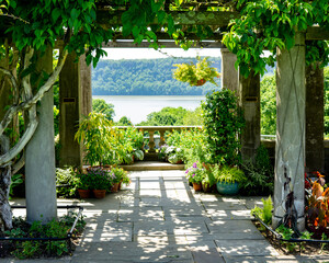 Bronx, NY - USA - June 4, 2022  closeup of the Pergola Overlook at Wave Hill, with the Hudson River and Palisades in the rear. Wave Hill is a 28-acre estate in the Hudson Hill section of Riverdale. - obrazy, fototapety, plakaty