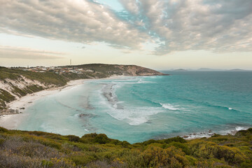 Beautiful white sand and blue crystal water at sunset in a cloudy day - West Beach, Esperance WA, Australia