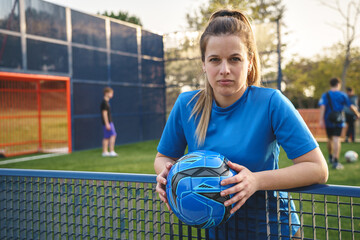Sportswoman with ball looking at camera
