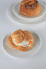 Delicious homemade choux pastry with custard and Marian Plum or Mayongchid. on white background