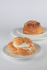 Delicious homemade choux pastry with custard and Marian Plum or Mayongchid. on white background