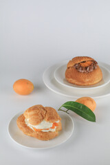 Delicious homemade choux pastry with custard and Marian Plum or Mayongchid. on white background