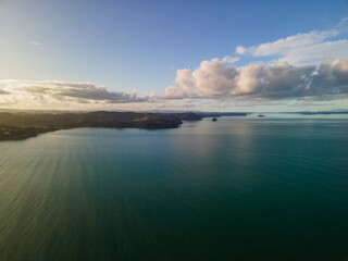 Aerial view of Orewa Beach in New Zealand through golden hour