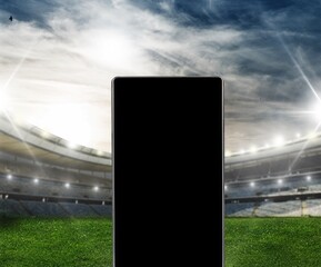 Smartphone with a blank screen on a football stadium